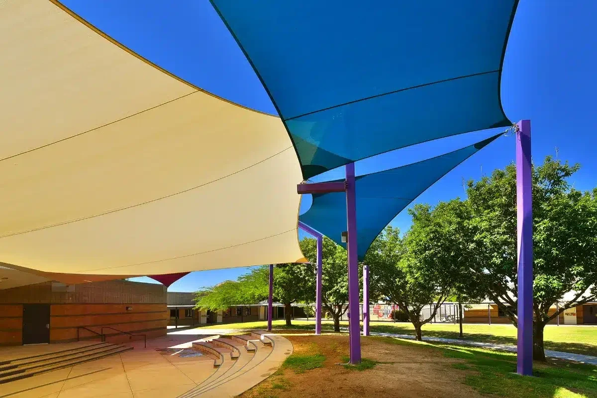 Colorful tensile shade sails over an Arizona outdoor courtyard