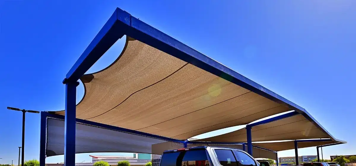 Beige shade panels in blue steel frames above a vehicle area at Dutch Bros, Val Vista